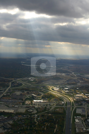 To use this stock image in your creative project, please select the size you need over to the right and click the "Add to Cart" button.
Your downloaded image will come with the Cutcaster watermark removed so don’t worry about the watermark you see on this page. Looking down the Plane stock photo, Aerial Shot from the Airplane with Sunrays coming through the clouds by Mehmet Dilsiz