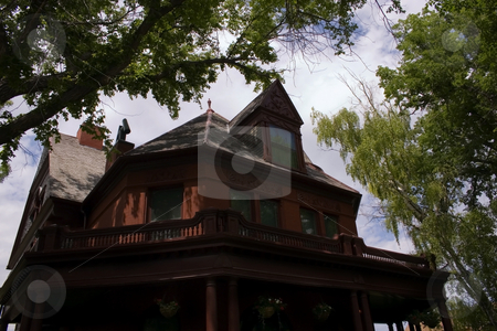 To use this stock image in your creative project, please select the size you need over to the right and click the "Add to Cart" button.
Your downloaded image will come with the Cutcaster watermark removed so don’t worry about the watermark you see on this page. Old Governer's Mansion in Helena Montana stock photo, Original Governer's Mansion in Helena Montana under the Trees by Mehmet Dilsiz