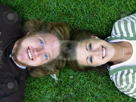 To use this stock image in your creative project, please select the size you need over to the right and click the "Add to Cart" button.
Your downloaded image will come with the Cutcaster watermark removed so don’t worry about the watermark you see on this page. Young couple looking at the Camera stock photo, Young Married Couple laying down looking up at the camera by Mehmet Dilsiz