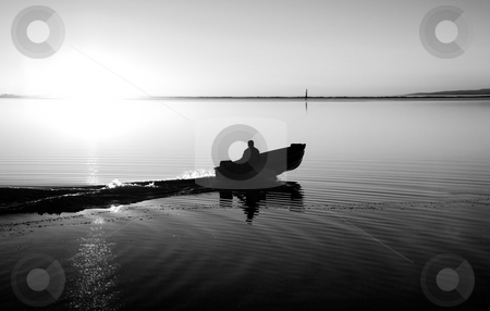 To use this stock image in your creative project, please select the size you need over to the right and click the "Add to Cart" button.
Your downloaded image will come with the Cutcaster watermark removed so don’t worry about the watermark you see on this page. Pacific Northwest Sunset stock photo, A man in a boat at Cline Spit in Sequim Washington. by Travis Manley