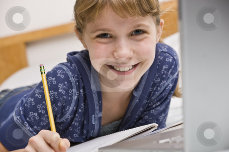 To use this stock image in your creative project, please select the size you need over to the right and click the "Add to Cart" button.
Your downloaded image will come with the Cutcaster watermark removed so don’t worry about the watermark you see on this page. Girl Working on Homework stock photo, A young girl is seated at a computer desk and is working on her homework. She is smilng at the camera. Horizontally framed shot. by Jonathan Ross