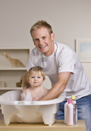 To use this stock image in your creative project, please select the size you need over to the right and click the "Add to Cart" button.
Your downloaded image will come with the Cutcaster watermark removed so don’t worry about the watermark you see on this page. Father Giving Daughter a Bath stock photo, A young father is giving his baby daughter a bath in a childs bathtub. He is smiling at the camera. Vertically framed shot. by Jonathan Ross