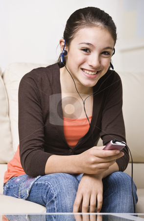 To use this stock image in your creative project, please select the size you need over to the right and click the "Add to Cart" button.
Your downloaded image will come with the Cutcaster watermark removed so don’t worry about the watermark you see on this page. Smiling Teenager Listening to Music stock photo, A happy young teenager listening to an MP3 music player. She is smiling at the camera. Vertically framed shot. by Jonathan Ross
