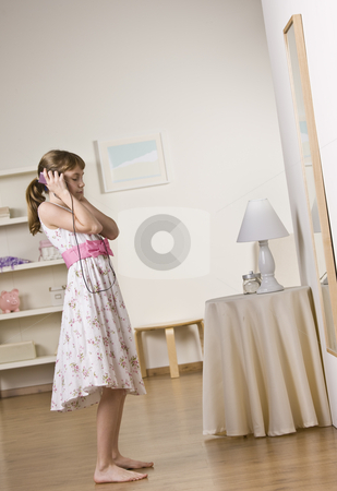 To use this stock image in your creative project, please select the size you need over to the right and click the "Add to Cart" button.
Your downloaded image will come with the Cutcaster watermark removed so don’t worry about the watermark you see on this page. Young Girl Listening to Music stock photo, A young girl listening to music with headphones. Vertically framed shot. by Jonathan Ross