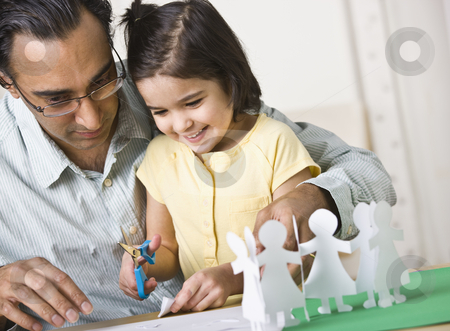 To use this stock image in your creative project, please select the size you need over to the right and click the "Add to Cart" button.
Your downloaded image will come with the Cutcaster watermark removed so don’t worry about the watermark you see on this page. Father Playing with Daughter stock photo, A father playing with his daughter. He is helping her cut out paper dolls and she is smiling. Horizontally framed shot. by Jonathan Ross