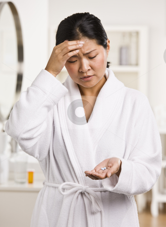To use this stock image in your creative project, please select the size you need over to the right and click the "Add to Cart" button.
Your downloaded image will come with the Cutcaster watermark removed so don’t worry about the watermark you see on this page. Woman with Headache stock photo, A young woman is holding pain medication that she is about to take for a headache. She is looking away from the camera. Vertically framed shot. by Jonathan Ross