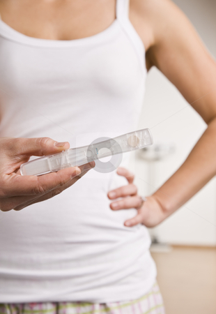 To use this stock image in your creative project, please select the size you need over to the right and click the "Add to Cart" button.
Your downloaded image will come with the Cutcaster watermark removed so don’t worry about the watermark you see on this page. Woman Holding Pregnancy Test stock photo, A woman is standing in her bathroom holding a pregnancy test in front of her. Vertically framed shot. by Jonathan Ross