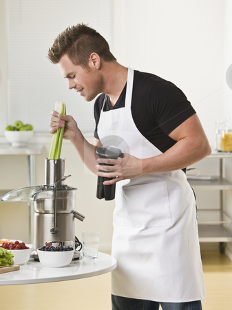 To use this stock image in your creative project, please select the size you need over to the right and click the "Add to Cart" button.
Your downloaded image will come with the Cutcaster watermark removed so don’t worry about the watermark you see on this page. Man Using Juicer stock photo, A young man is using a juicer in a kitchen. Vertically framed shot. by Jonathan Ross