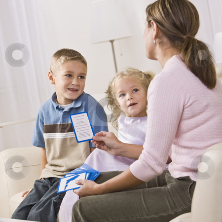 To use this stock image in your creative project, please select the size you need over to the right and click the "Add to Cart" button.
Your downloaded image will come with the Cutcaster watermark removed so don’t worry about the watermark you see on this page. Mother Playing with Children stock photo, A mother is playing cards with her children. They are smiling and looking at her. Vertically framed shot. by Jonathan Ross