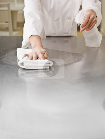 To use this stock image in your creative project, please select the size you need over to the right and click the "Add to Cart" button.
Your downloaded image will come with the Cutcaster watermark removed so don’t worry about the watermark you see on this page. Chef Cleaning Counter stock photo, A chef is cleaning a counter in a professional kitchen with a bottle of solution and a rag. Vertically framed shot. by Jonathan Ross