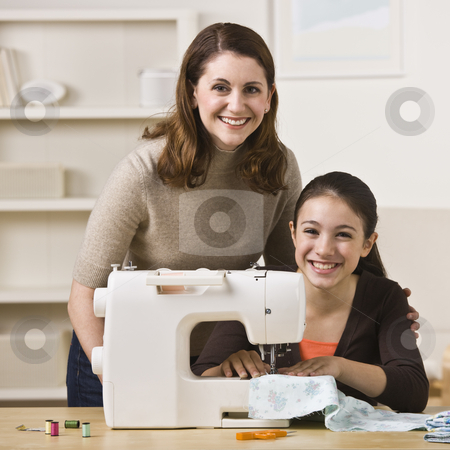 To use this stock image in your creative project, please select the size you need over to the right and click the "Add to Cart" button.
Your downloaded image will come with the Cutcaster watermark removed so don’t worry about the watermark you see on this page. Mother and Daughter Sewing stock photo, A beautiful young girl sewing with her mother. They are smiling at the camera. Square framed shot. by Jonathan Ross