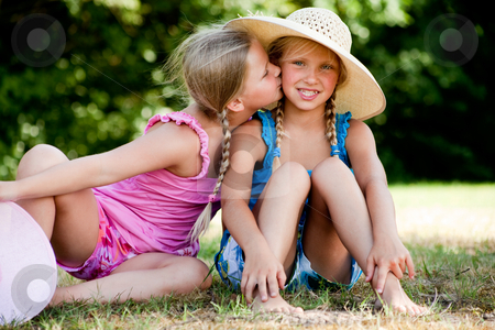 To use this stock image in your creative project, please select the size you need over to the right and click the "Add to Cart" button.
Your downloaded image will come with the Cutcaster watermark removed so don’t worry about the watermark you see on this page. Kiss on my sisters cheek stock photo, Two little girls in fresh colors in the park by Frenk and Danielle Kaufmann