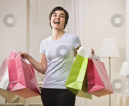 To use this stock image in your creative project, please select the size you need over to the right and click the "Add to Cart" button.
Your downloaded image will come with the Cutcaster watermark removed so don’t worry about the watermark you see on this page. Smiling woman with shopping bags. stock photo, Woman with multi-colored shopping bags, smiling for the camera. Horizontal. by Jonathan Ross
