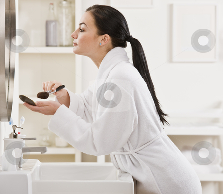To use this stock image in your creative project, please select the size you need over to the right and click the "Add to Cart" button.
Your downloaded image will come with the Cutcaster watermark removed so don’t worry about the watermark you see on this page. Woman Putting on Makeup stock photo, A young woman is standing in front of the bathroom mirror and putting on makeup. Horizontally framed shot. by Jonathan Ross