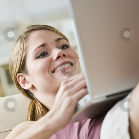 To use this stock image in your creative project, please select the size you need over to the right and click the "Add to Cart" button.
Your downloaded image will come with the Cutcaster watermark removed so don’t worry about the watermark you see on this page. Attractive blonde with computer. stock photo, Attractive blonde woman relaxing with laptop computer.Smiling, looking at the laptop.Square. by Jonathan Ross