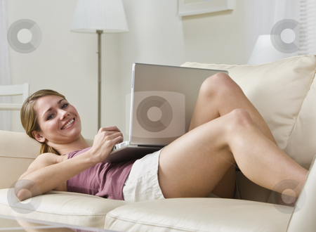 To use this stock image in your creative project, please select the size you need over to the right and click the "Add to Cart" button.
Your downloaded image will come with the Cutcaster watermark removed so don’t worry about the watermark you see on this page. Attractive blonde with laptop. stock photo, Attractive blonde woman lying on couch with laptop, smiling at camera. Horizontal by Jonathan Ross