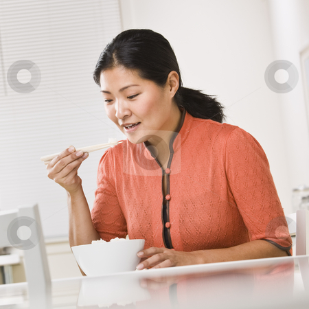 To use this stock image in your creative project, please select the size you need over to the right and click the "Add to Cart" button.
Your downloaded image will come with the Cutcaster watermark removed so don’t worry about the watermark you see on this page. Asian woman eating rice. stock photo, Asian woman eating a bowl of rice with chopsticks. Square by Jonathan Ross