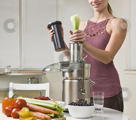 To use this stock image in your creative project, please select the size you need over to the right and click the "Add to Cart" button.
Your downloaded image will come with the Cutcaster watermark removed so don’t worry about the watermark you see on this page. Attractive woman using juicer stock photo, Attractive woman with juicer machine, adding celery and smiling. Horizontal. by Jonathan Ross