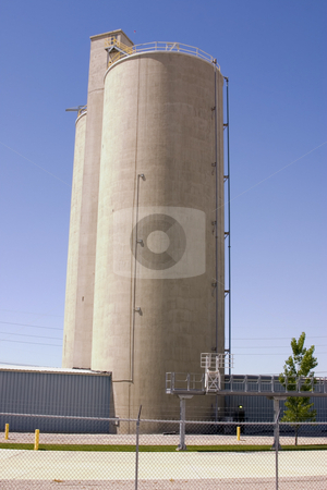 To use this stock image in your creative project, please select the size you need over to the right and click the "Add to Cart" button.
Your downloaded image will come with the Cutcaster watermark removed so don’t worry about the watermark you see on this page. Sile behind Fences stock photo, Silo behind fences with clear blue skies by Mehmet Dilsiz