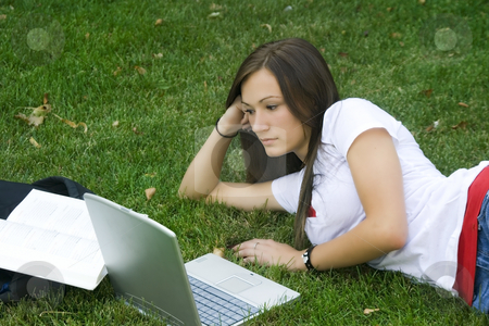 To use this stock image in your creative project, please select the size you need over to the right and click the "Add to Cart" button.
Your downloaded image will come with the Cutcaster watermark removed so don’t worry about the watermark you see on this page. Cute teen girl laying down on the grass studying stock photo, Cute teen girl laying down on the grass studying with her laptop by Mehmet Dilsiz