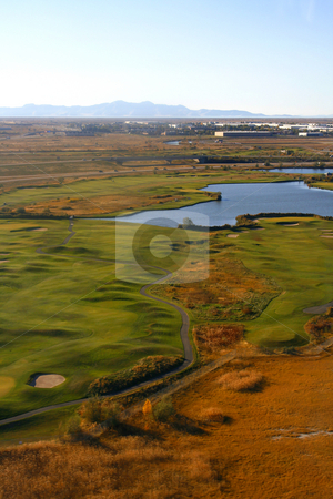 To use this stock image in your creative project, please select the size you need over to the right and click the "Add to Cart" button.
Your downloaded image will come with the Cutcaster watermark removed so don’t worry about the watermark you see on this page. Overlooking at a Golf Course and a Pond stock photo, Aerial Shot of a Golf Course by Mehmet Dilsiz