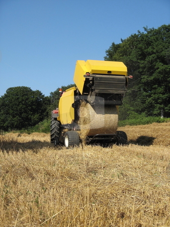 To use this stock image in your creative project, please select the size you need over to the right and click the "Add to Cart" button.
Your downloaded image will come with the Cutcaster watermark removed so don’t worry about the watermark you see on this page. Round Baler stock photo, A round baler discharges a wheat bale during harvesting of winter fodder for the livestock. by Gozzoli