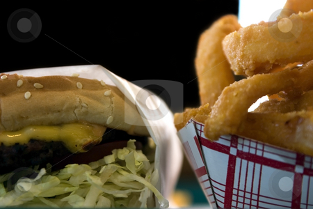To use this stock image in your creative project, please select the size you need over to the right and click the "Add to Cart" button.
Your downloaded image will come with the Cutcaster watermark removed so don’t worry about the watermark you see on this page. Close up on Onion Rings and a Hamburger stock photo, Close up shot of Onion Rings and a Hamburger by Mehmet Dilsiz