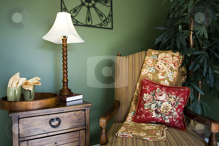 To use this stock image in your creative project, please select the size you need over to the right and click the "Add to Cart" button.
Your downloaded image will come with the Cutcaster watermark removed so don’t worry about the watermark you see on this page. Family Room with Reading Chair and night stand stock photo, Close up on a corner of a house with a chair and nightstand by Mehmet Dilsiz
