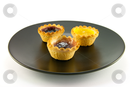 To use this stock image in your creative project, please select the size you need over to the right and click the "Add to Cart" button.
Your downloaded image will come with the Cutcaster watermark removed so don’t worry about the watermark you see on this page. Three Jam Tarts on a Plate stock photo, Three red and yellow small pastry jam tarts on a black plate with a white background by Keith Wilson