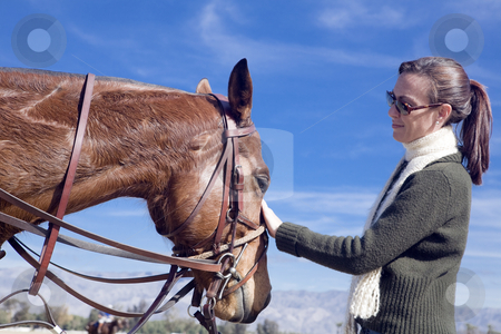 To use this stock image in your creative project, please select the size you need over to the right and click the "Add to Cart" button.
Your downloaded image will come with the Cutcaster watermark removed so don’t worry about the watermark you see on this page. Woman with Horse stock photo, Woman comforts a polo horse before a chucker by Bart Everett