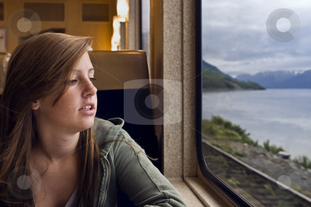 To use this stock image in your creative project, please select the size you need over to the right and click the "Add to Cart" button.
Your downloaded image will come with the Cutcaster watermark removed so don’t worry about the watermark you see on this page. Train Trip stock photo, A young girl gazes out the window of a dining car on the Alaska Railroad by Bart Everett