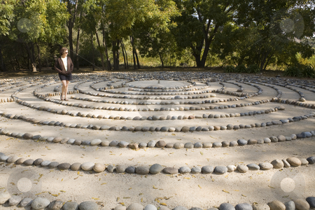 To use this stock image in your creative project, please select the size you need over to the right and click the "Add to Cart" button.
Your downloaded image will come with the Cutcaster watermark removed so don’t worry about the watermark you see on this page. Labyrinth stock photo, In deep thought, a lone woman walks a forest labyrinth by Bart Everett