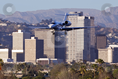 To use this stock image in your creative project, please select the size you need over to the right and click the "Add to Cart" button.
Your downloaded image will come with the Cutcaster watermark removed so don’t worry about the watermark you see on this page. Century City Jet stock photo, Small jet airplane flies near Century City skyscrapers on landing approach to Santa Monica Airport by Bart Everett
