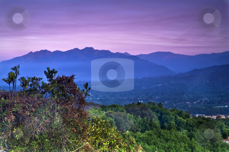To use this stock image in your creative project, please select the size you need over to the right and click the "Add to Cart" button.
Your downloaded image will come with the Cutcaster watermark removed so don’t worry about the watermark you see on this page. Overlooking the Ojai Valley stock photo, View looking west at sunrise from the Ojai Valley Rotary monument on California Highway 150 by Bart Everett