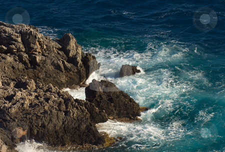 To use this stock image in your creative project, please select the size you need over to the right and click the "Add to Cart" button.
Your downloaded image will come with the Cutcaster watermark removed so don’t worry about the watermark you see on this page. Rocks stock photo, Image shows a stormy sea hitting a rocky cosatline, photographed from above by Andreas Karelias
