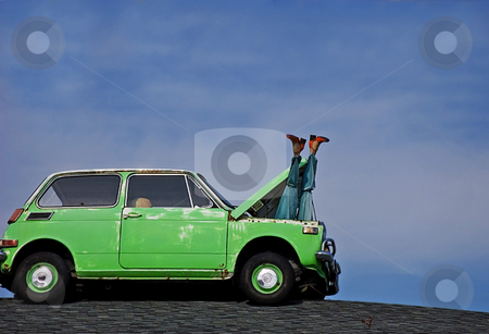 To use this stock image in your creative project, please select the size you need over to the right and click the "Add to Cart" button.
Your downloaded image will come with the Cutcaster watermark removed so don’t worry about the watermark you see on this page. Humorous Mannequin Legs Sticking Out of Car stock photo, This humorous photo depicts a woman's mannequin legs sticking out of the hood of a small green car's hood against bright blue sky. by Valerie Garner