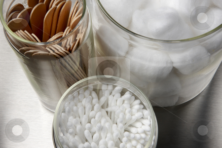 To use this stock image in your creative project, please select the size you need over to the right and click the "Add to Cart" button.
Your downloaded image will come with the Cutcaster watermark removed so don’t worry about the watermark you see on this page. Medical supplies stock photo, Tongue depressors, cotton swaps and cotton balls in glass containers on a stainless surface by James Barber