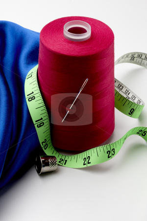 To use this stock image in your creative project, please select the size you need over to the right and click the "Add to Cart" button.
Your downloaded image will come with the Cutcaster watermark removed so don’t worry about the watermark you see on this page. A sewing still life stock photo, A spool of red thread, blue material, green tape measure, sewing needle and thimble by James Barber