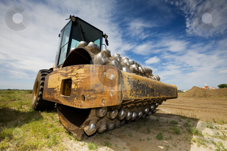 To use this stock image in your creative project, please select the size you need over to the right and click the "Add to Cart" button.
Your downloaded image will come with the Cutcaster watermark removed so don’t worry about the watermark you see on this page. Packer stock photo, A large yellow packer at a construction site low angle view by Steve Mcsweeny