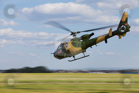 To use this stock image in your creative project, please select the size you need over to the right and click the "Add to Cart" button.
Your downloaded image will come with the Cutcaster watermark removed so don’t worry about the watermark you see on this page. Helicopter stock photo, Army helicopter flying low at high speed by Steve Mcsweeny