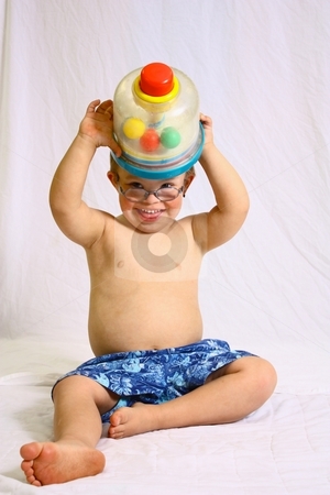 To use this stock image in your creative project, please select the size you need over to the right and click the "Add to Cart" button.
Your downloaded image will come with the Cutcaster watermark removed so don’t worry about the watermark you see on this page. Little boy with glasses playing with toy. stock photo, Little boy with toy by Gregory Dean