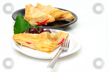 To use this stock image in your creative project, please select the size you need over to the right and click the "Add to Cart" button.
Your downloaded image will come with the Cutcaster watermark removed so don’t worry about the watermark you see on this page. Cherry Turnover stock photo, Cherry turnovers with fresh cherries on a white saucer with adiitional parties on a black plate in the background by Lynn Bendickson