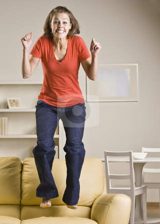 To use this stock image in your creative project, please select the size you need over to the right and click the "Add to Cart" button.
Your downloaded image will come with the Cutcaster watermark removed so don’t worry about the watermark you see on this page. Teenage girl jumping on sofa stock photo, Teenage girl jumping on sofa by Jonathan Ross