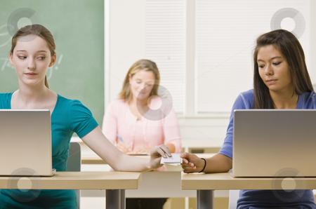 To use this stock image in your creative project, please select the size you need over to the right and click the "Add to Cart" button.
Your downloaded image will come with the Cutcaster watermark removed so don’t worry about the watermark you see on this page. Students passing notes in classroom stock photo, Students passing notes in classroom by Jonathan Ross
