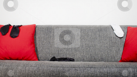To use this stock image in your creative project, please select the size you need over to the right and click the "Add to Cart" button.
Your downloaded image will come with the Cutcaster watermark removed so don’t worry about the watermark you see on this page. Sofa and socks stock photo, Socks in a sofa with pillows by Fredrik Elfdahl