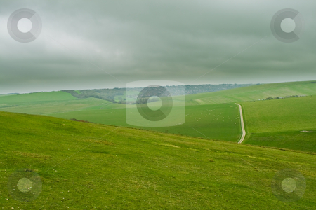 To use this stock image in your creative project, please select the size you need over to the right and click the "Add to Cart" button.
Your downloaded image will come with the Cutcaster watermark removed so don’t worry about the watermark you see on this page. Green hill stock photo, Green hill with a road by Fredrik Elfdahl
