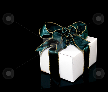 To use this stock image in your creative project, please select the size you need over to the right and click the "Add to Cart" button.
Your downloaded image will come with the Cutcaster watermark removed so don’t worry about the watermark you see on this page. One Gift With Green Ribbon stock photo, This is one gift in a white box with a green metallic gold edged wire ribbon against a black background. by Valerie Garner