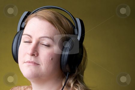 To use this stock image in your creative project, please select the size you need over to the right and click the "Add to Cart" button.
Your downloaded image will come with the Cutcaster watermark removed so don’t worry about the watermark you see on this page. Woman listing to music stock photo, Women listing to music with her eye close by Yann Poirier