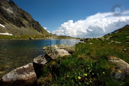 To use this stock image in your creative project, please select the size you need over to the right and click the "Add to Cart" button.
Your downloaded image will come with the Cutcaster watermark removed so don’t worry about the watermark you see on this page. Mountain lake and grass stock photo, Mountain lake and green grass on plateau in sunny summer day with some clouds on horizon by Juraj Kovacik