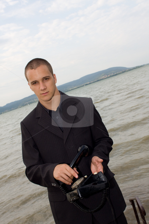 To use this stock image in your creative project, please select the size you need over to the right and click the "Add to Cart" button.
Your downloaded image will come with the Cutcaster watermark removed so don’t worry about the watermark you see on this page. Businessman with retro phone stock photo, Businessman use old vintage dial telephone by Istv??n Cs??k